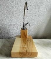 Wooden stand for a drinking water tap. The original installation of the water filter