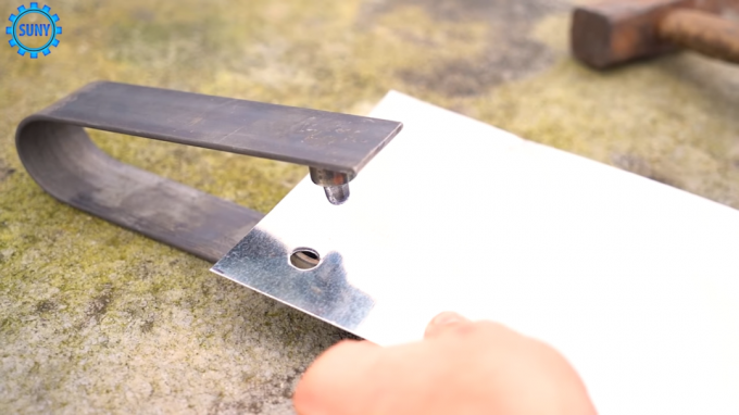 The process of making holes in the metal sheet by using a homemade instrument