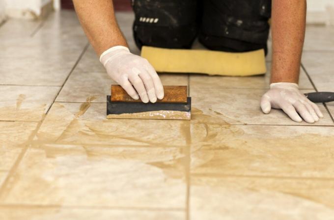 Application of grout with a rubber trowel