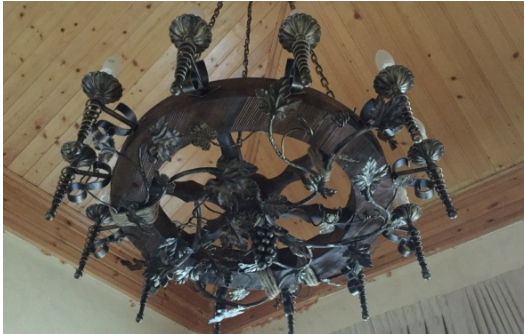 Decorative chandelier-wheel gives the interior finish.
